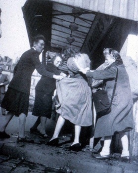 1947, when a discontented crowd in the street attacks the first winners of the “New Look,” tearing off their clothes.jpg