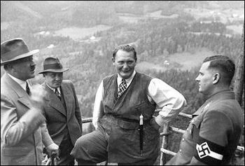 Baldur von Schirach (right) listens to Hitler as Bormann and Göring.jpg