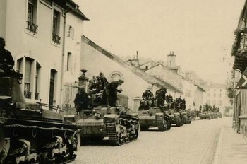 Column of PzKpfw 35(t)s at a stop in a French town-1940.jpg