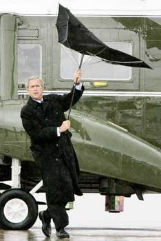 George W. Bush holds onto his umbrella during a rainstorm.jpg