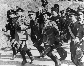 Italian fascist dictator Benito Mussolini leads his officers in a spirited run in full military regalia.jpg