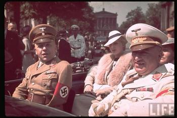 Nazi leaders Max Amann (Reich Press Chamber) and Robert Ley (German Labour Front) in Berlin, June 1939. The attractive lady in the back seat is Frau Ley.jpg